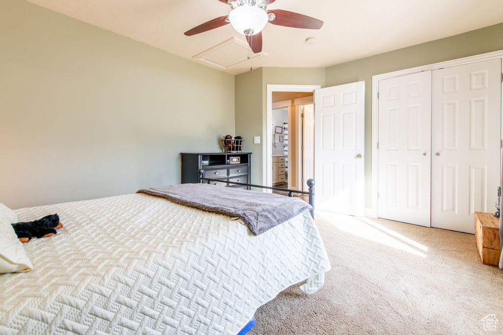 Bedroom featuring carpet, ceiling fan, and a closet