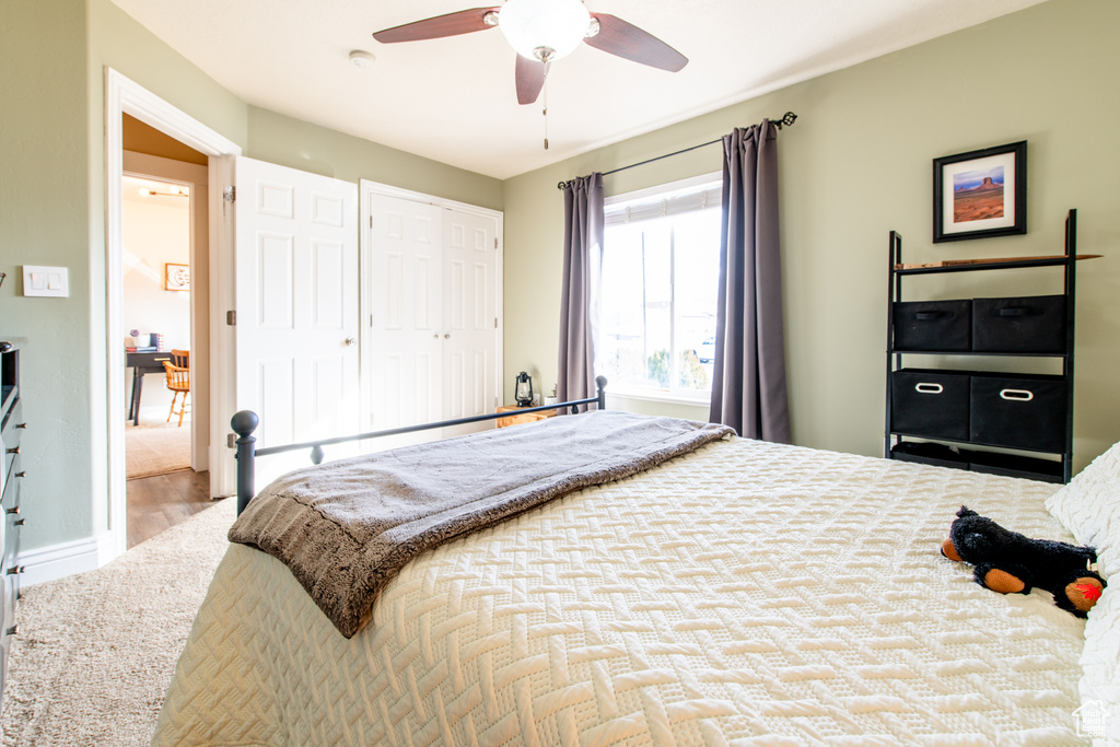 Bedroom with ceiling fan, a closet, and baseboards