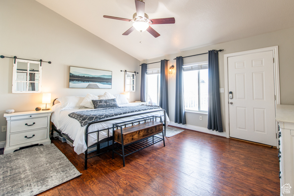 Bedroom featuring lofted ceiling, ceiling fan, baseboards, and wood finished floors