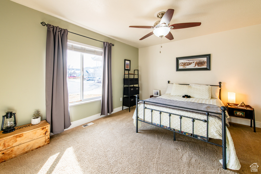 Bedroom featuring carpet floors, baseboards, and visible vents