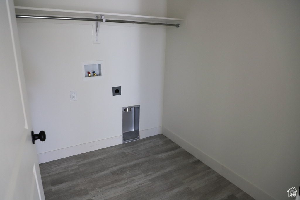 Laundry room featuring hookup for a washing machine, dark wood-type flooring, electric dryer hookup, laundry area, and baseboards