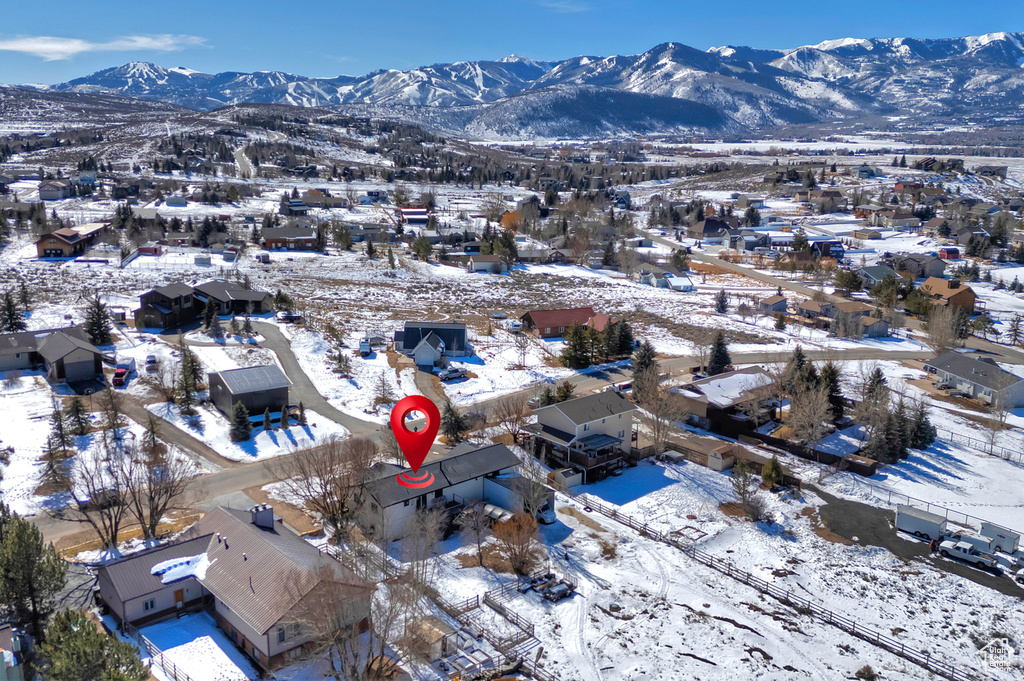 Snowy aerial view with a residential view and a mountain view