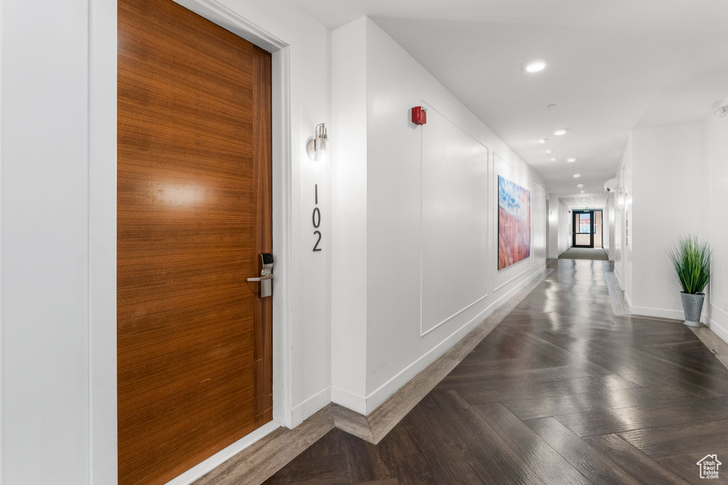 Corridor featuring baseboards and recessed lighting