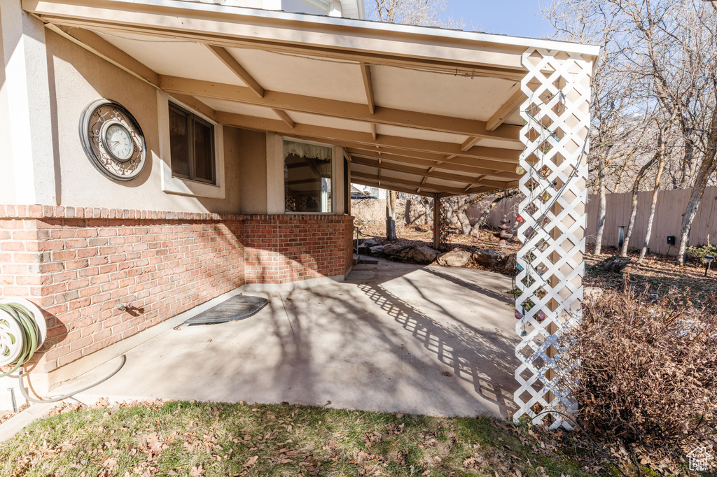 View of patio featuring fence