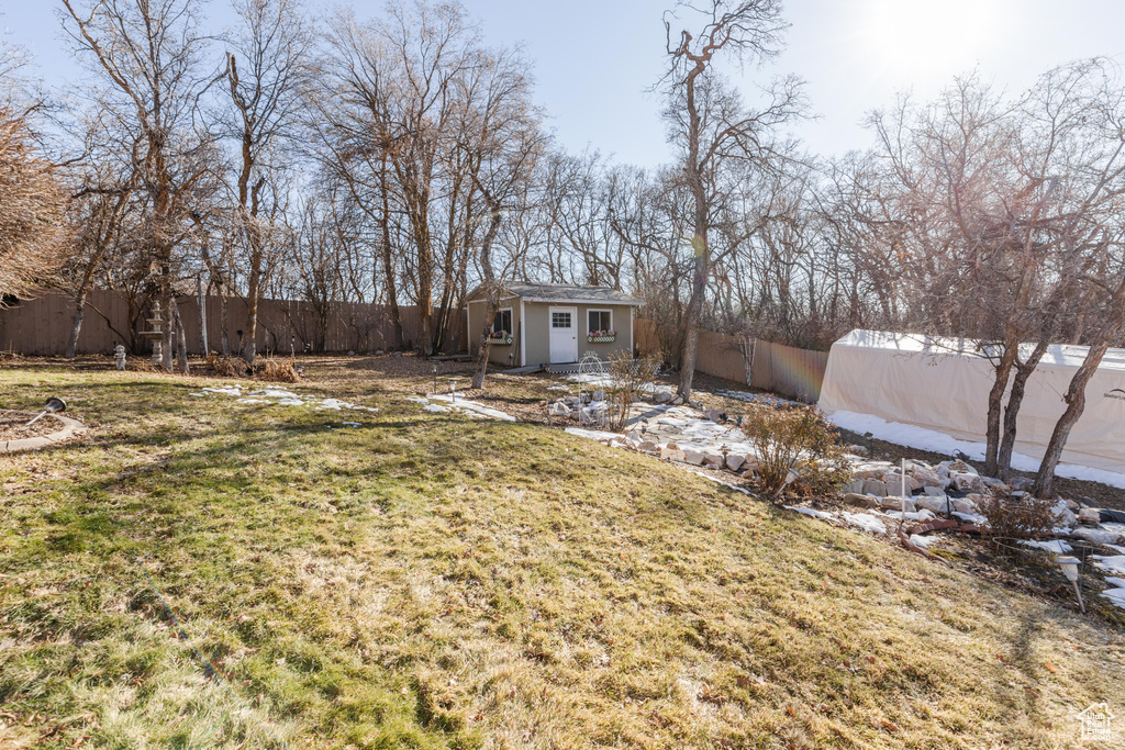 View of yard with an outbuilding and a fenced backyard