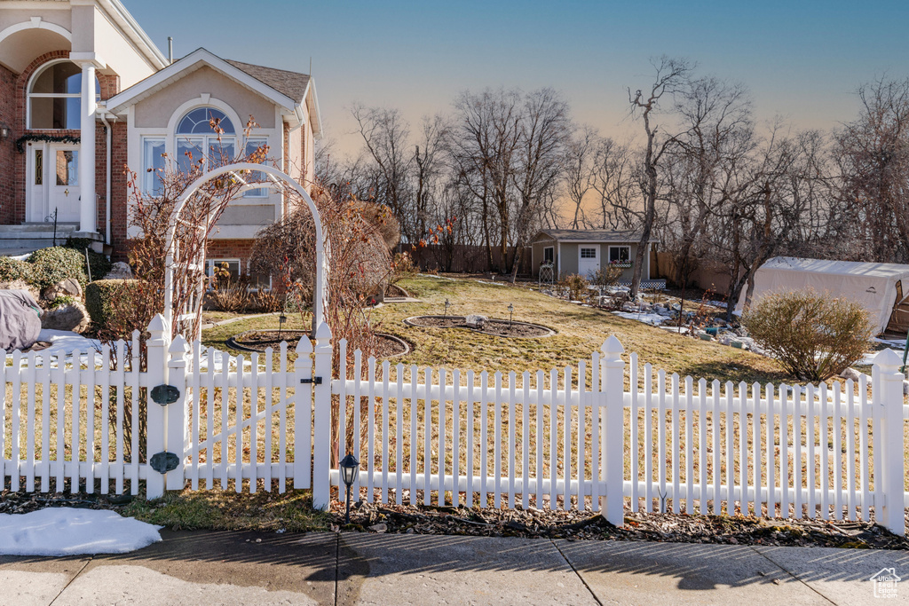 View of yard featuring fence and an outbuilding