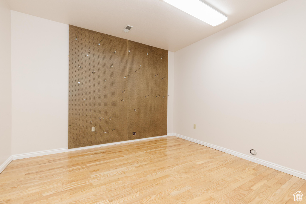 Spare room featuring light wood finished floors and baseboards