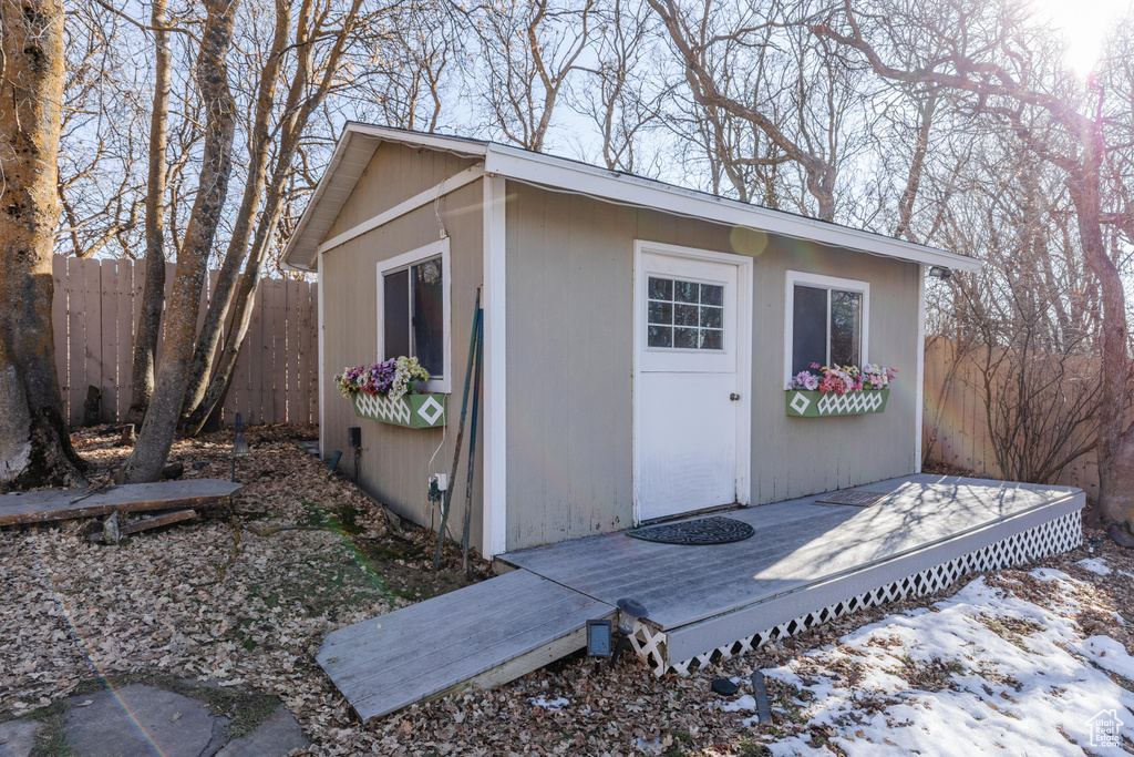 View of outbuilding with fence and an outdoor structure