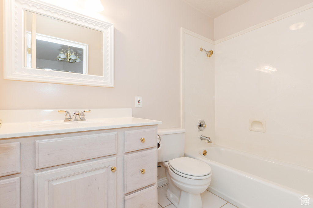 Bathroom featuring vanity, shower / washtub combination, tile patterned flooring, and toilet