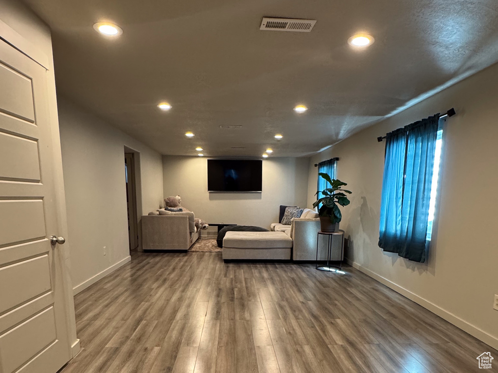 Unfurnished living room featuring wood finished floors, recessed lighting, visible vents, and baseboards