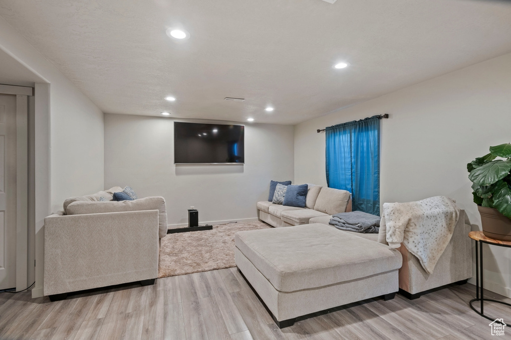 Living room featuring wood finished floors and recessed lighting
