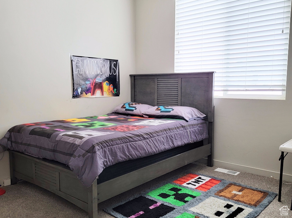 Carpeted bedroom with baseboards