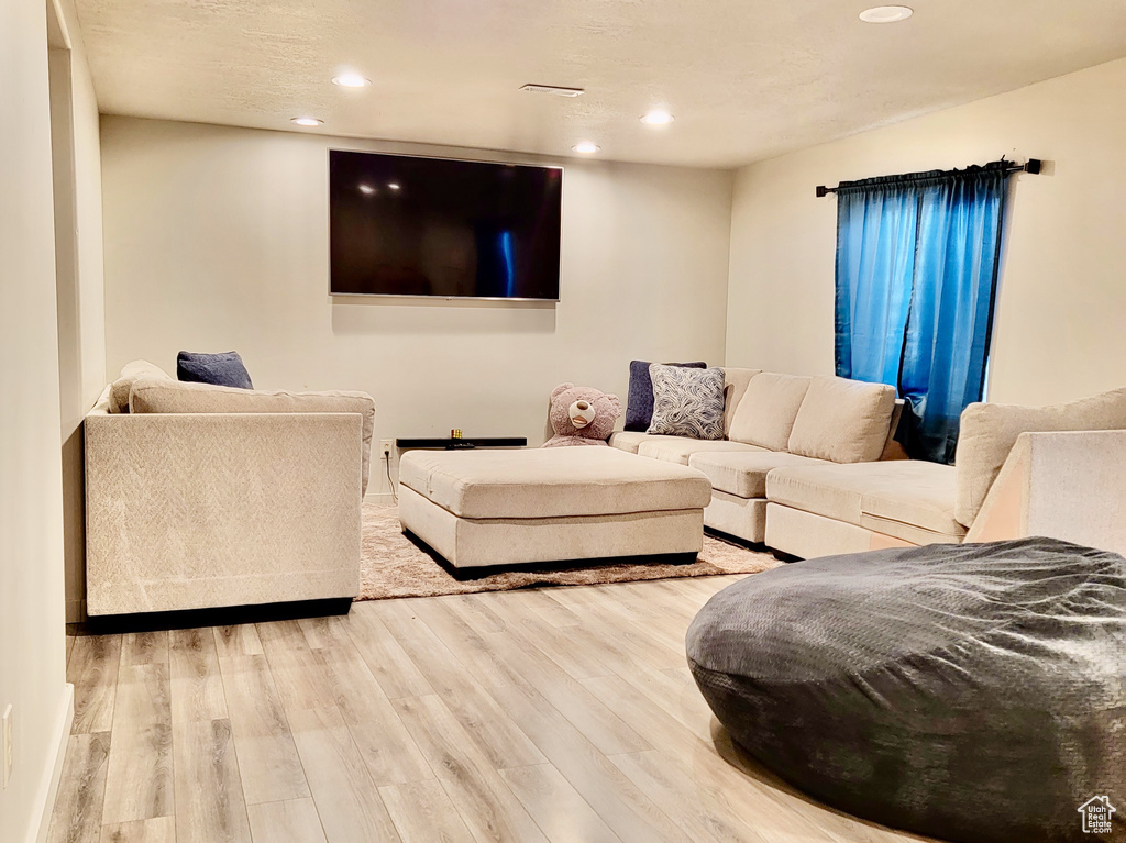 Living area featuring visible vents, wood finished floors, and recessed lighting