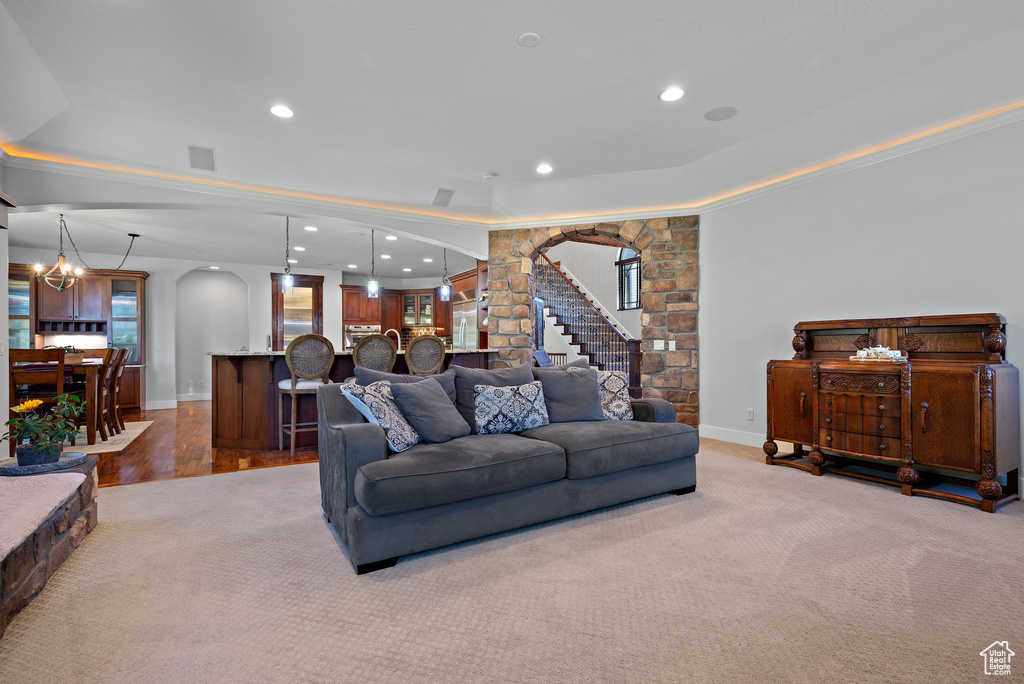 Living area with recessed lighting, arched walkways, and visible vents