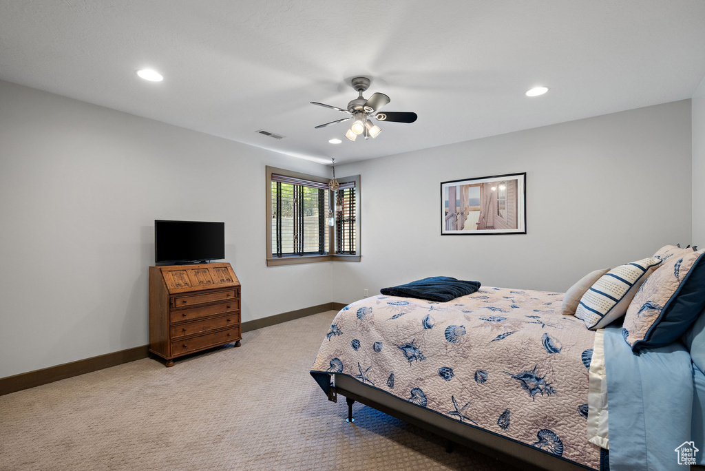 Bedroom with baseboards, light carpet, recessed lighting, and visible vents