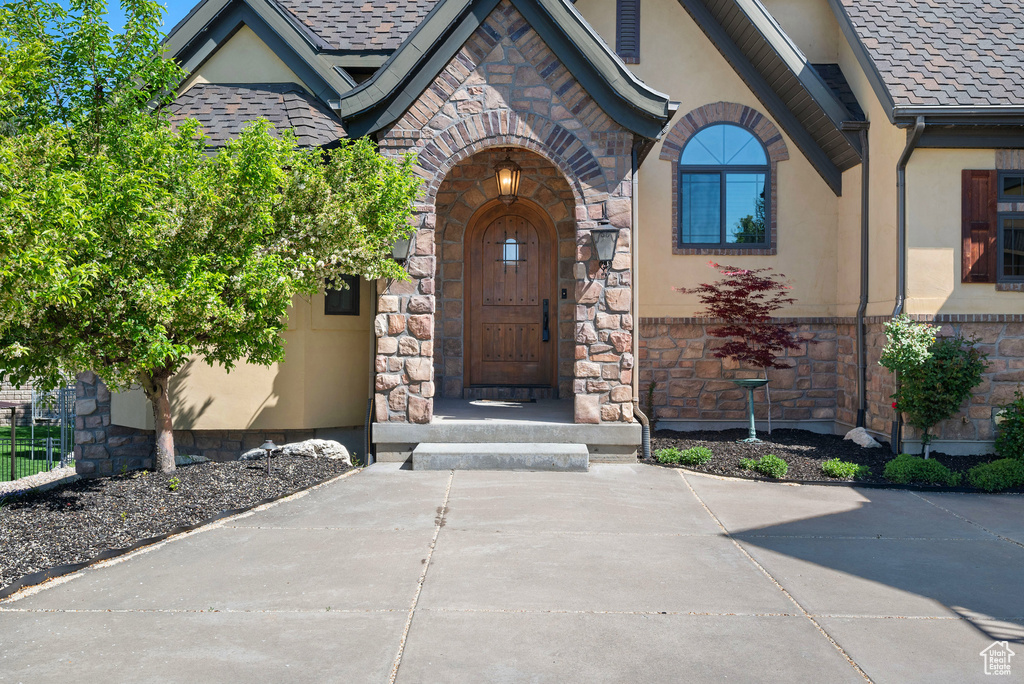 Property entrance with stucco siding and stone siding