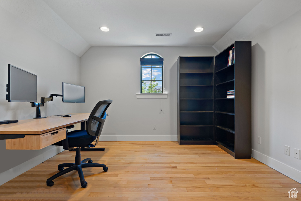 Office with light wood-style floors, baseboards, recessed lighting, and visible vents