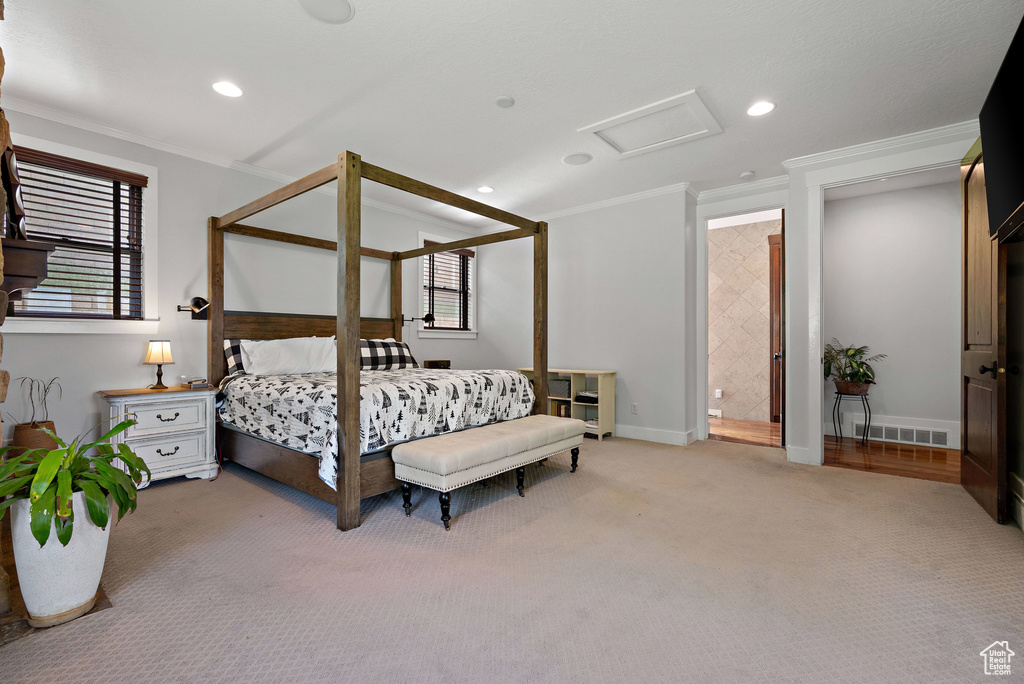 Carpeted bedroom with baseboards, ornamental molding, attic access, and recessed lighting