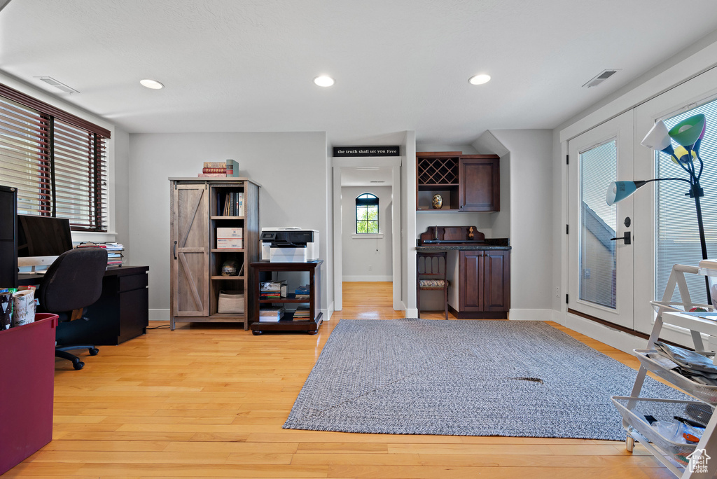 Office featuring recessed lighting, baseboards, visible vents, and light wood-style flooring