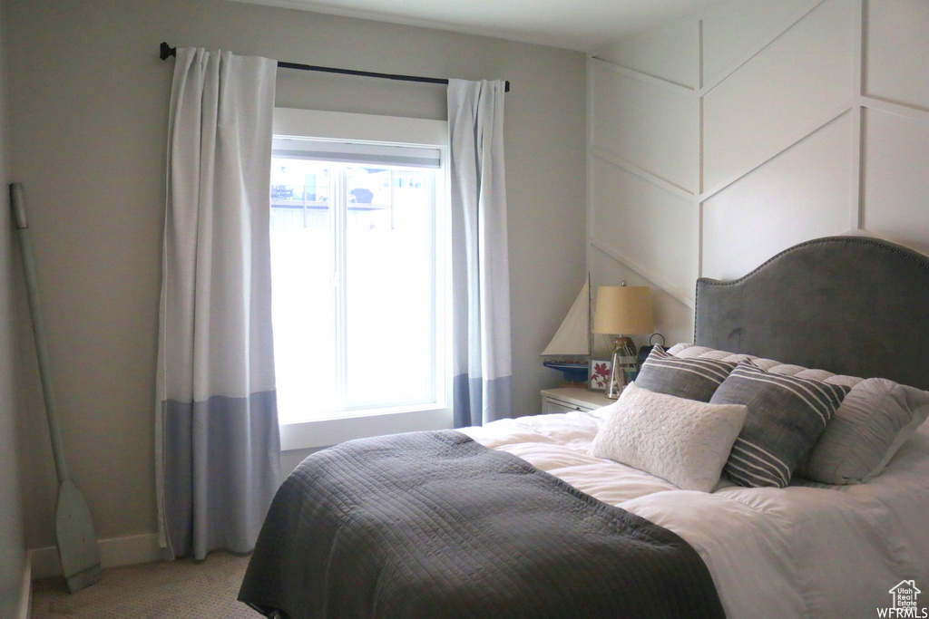 Bedroom featuring light colored carpet