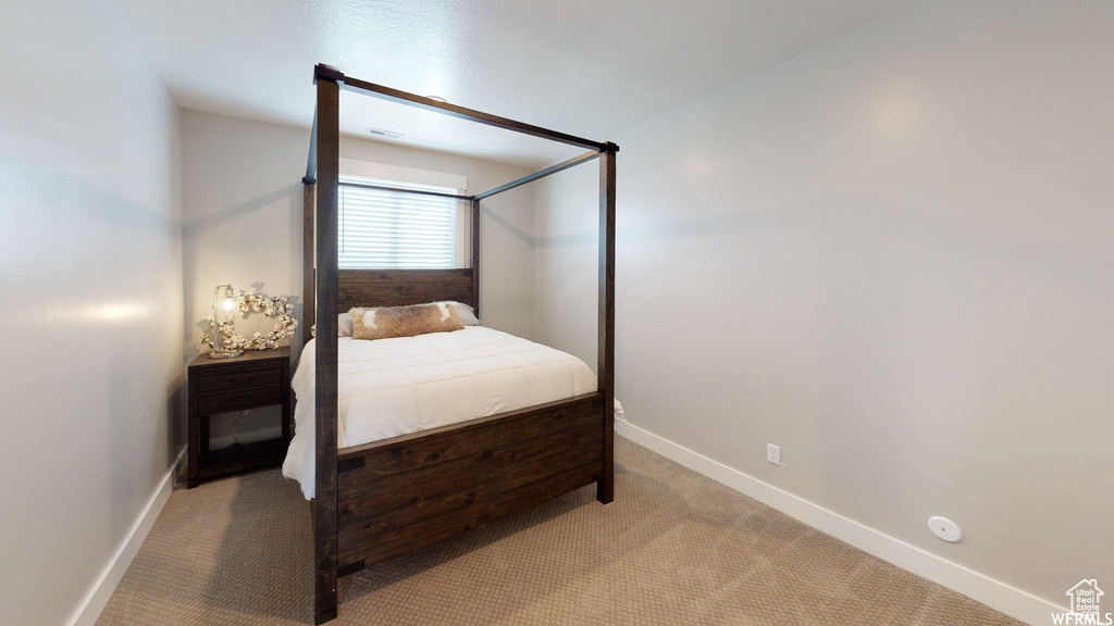 Carpeted bedroom with baseboards