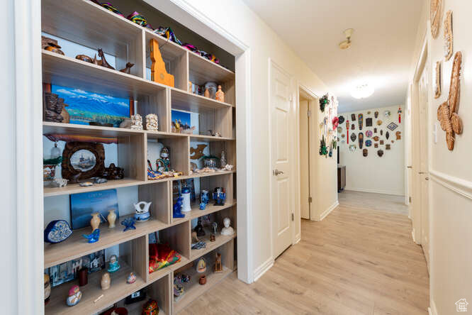 Hall with wood finished floors and baseboards