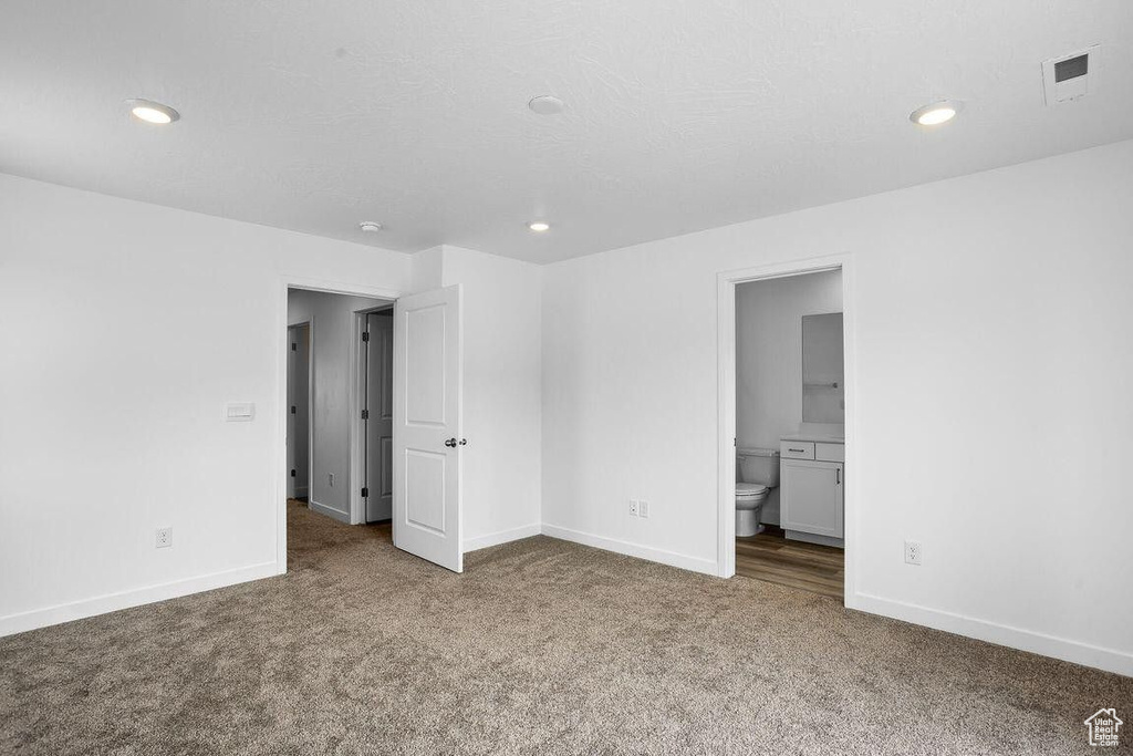 Unfurnished bedroom featuring carpet floors, recessed lighting, visible vents, and baseboards