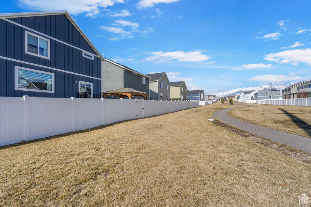 View of yard featuring fence and a residential view