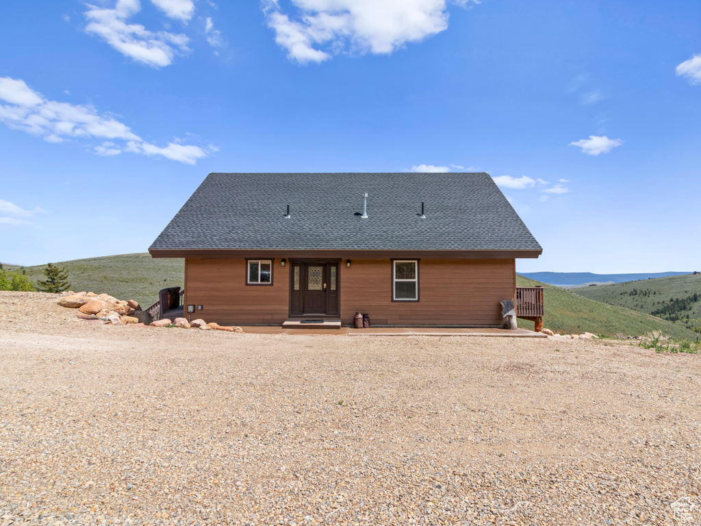 Rear view of house with roof with shingles
