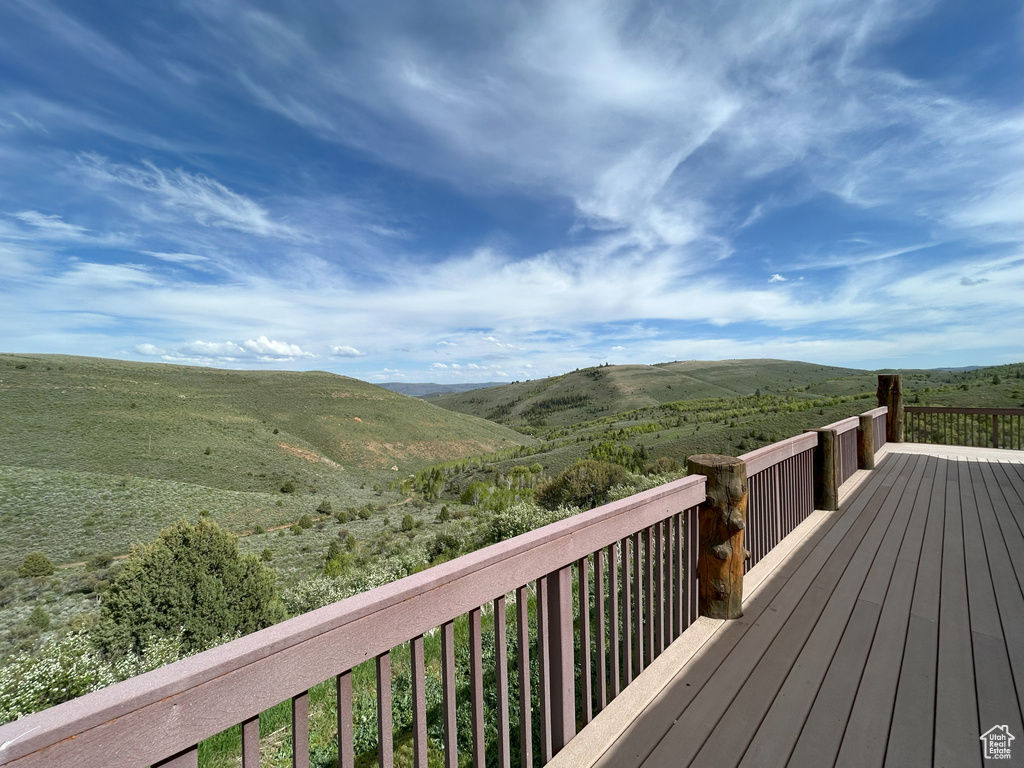 Wooden terrace featuring a mountain view