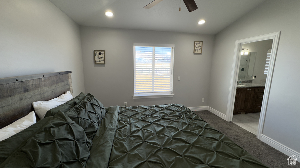 Bedroom with carpet floors, recessed lighting, ensuite bathroom, vaulted ceiling, and baseboards