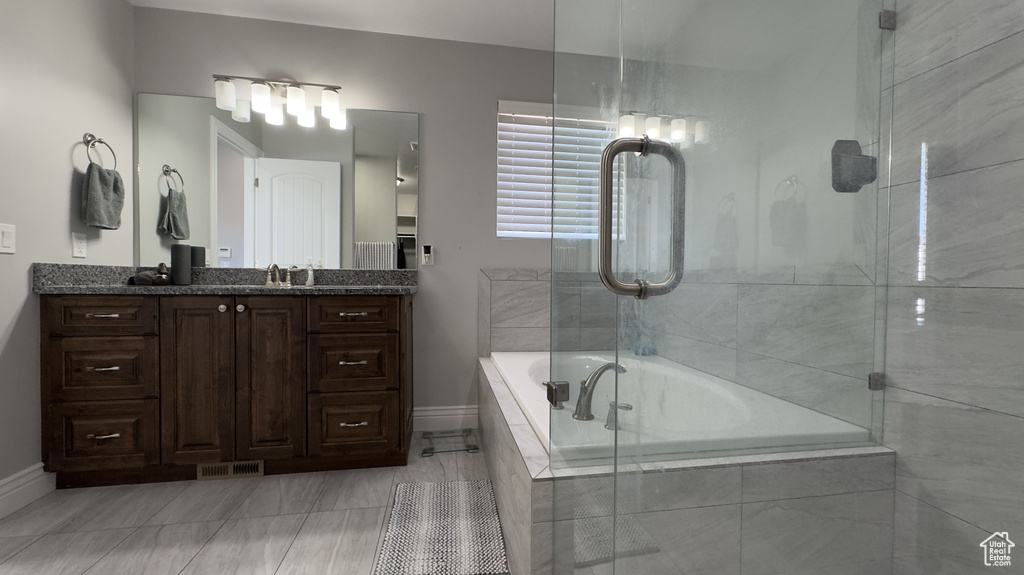 Bathroom featuring visible vents, vanity, and baseboards