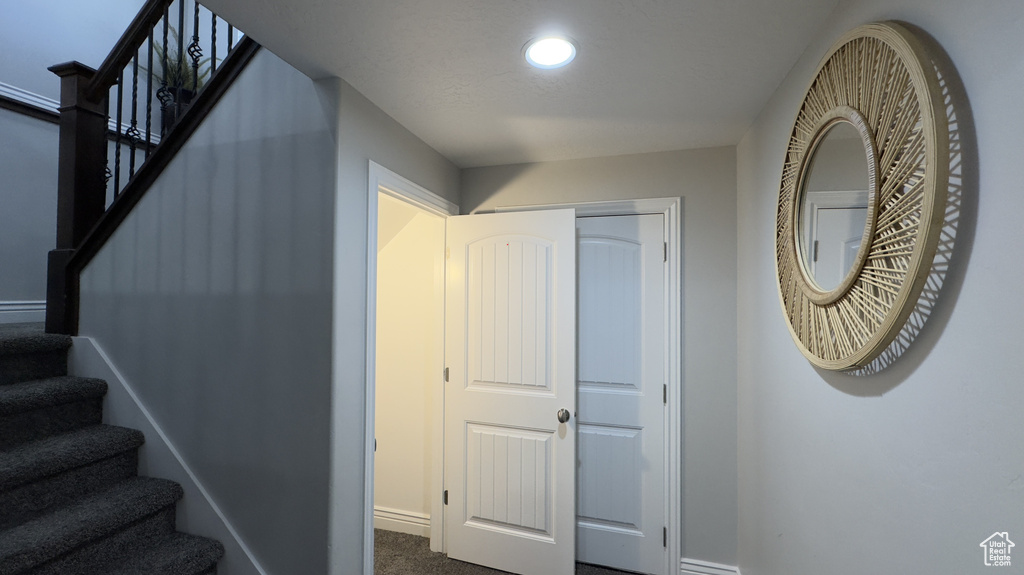 Stairway featuring carpet, baseboards, and recessed lighting