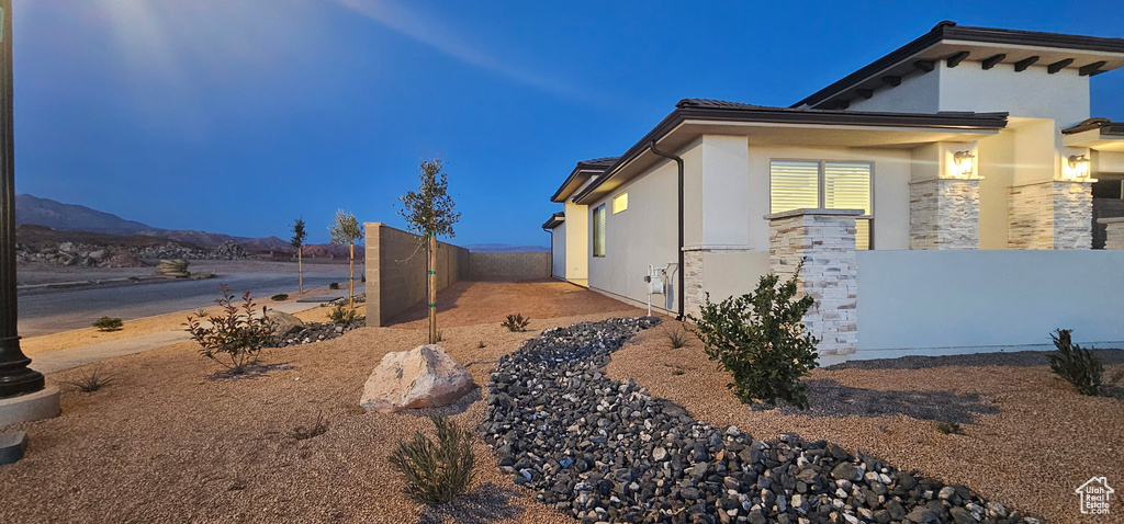 View of property exterior with fence and stucco siding