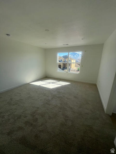 Unfurnished room featuring carpet flooring and baseboards