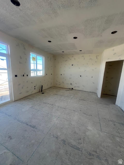 Unfurnished room featuring a textured ceiling