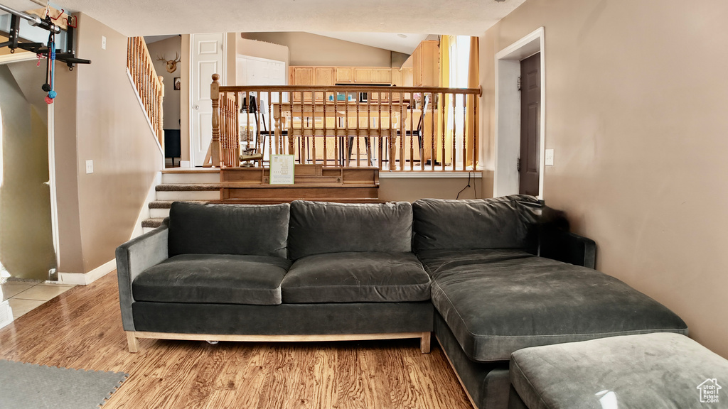 Living area with wood finished floors, stairway, and baseboards