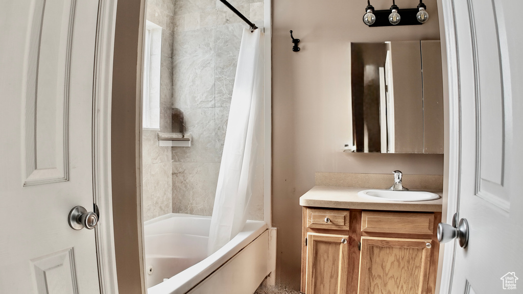 Full bathroom featuring shower / bath combo and vanity