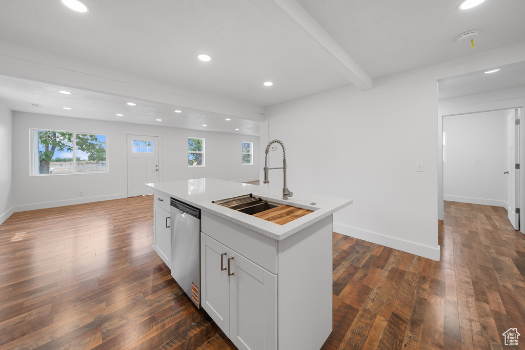 Kitchen with stainless steel dishwasher, recessed lighting, a kitchen island with sink, plenty of natural light, and light countertops