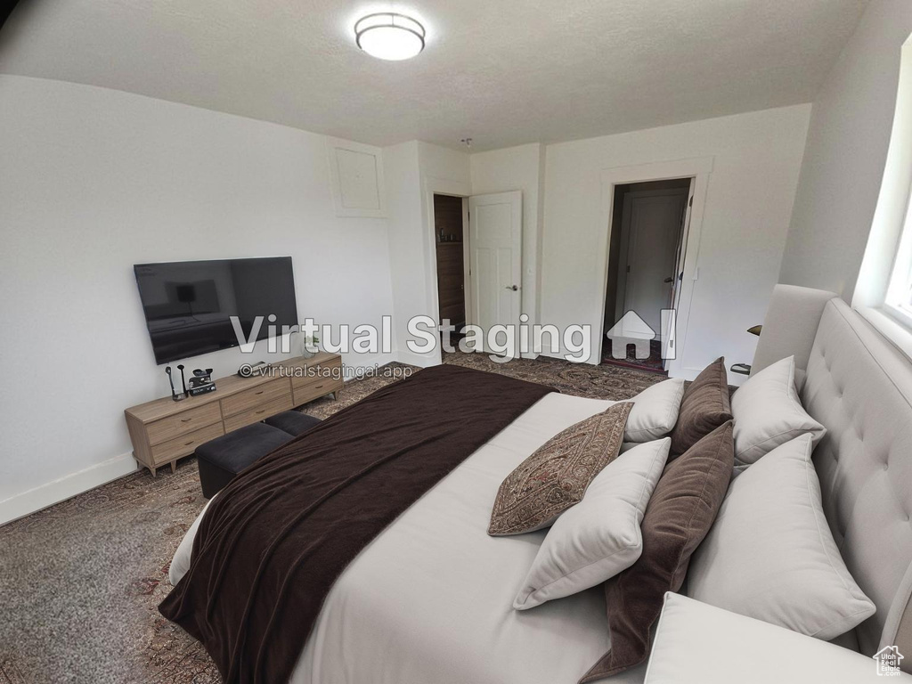 Bedroom featuring carpet flooring and baseboards
