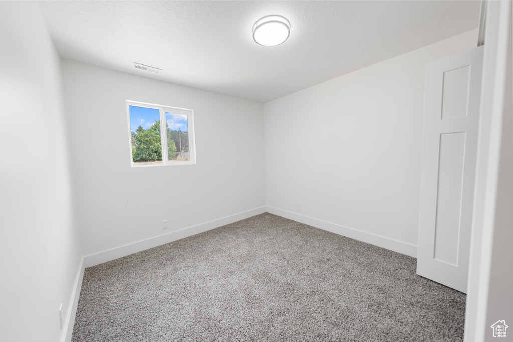 Spare room featuring carpet