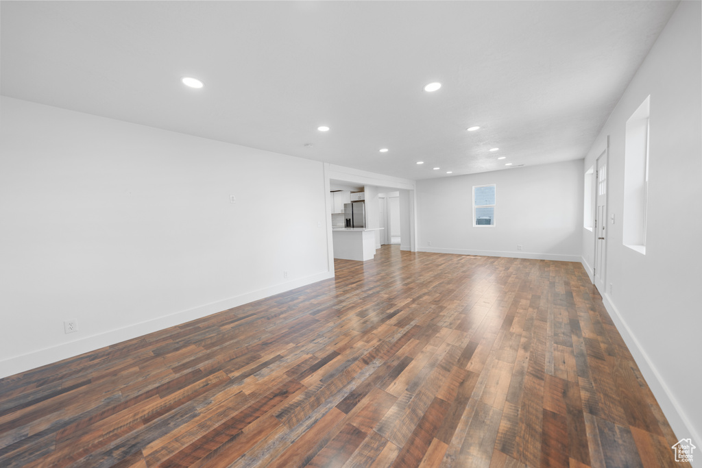 Unfurnished living room featuring recessed lighting and dark wood finished floors