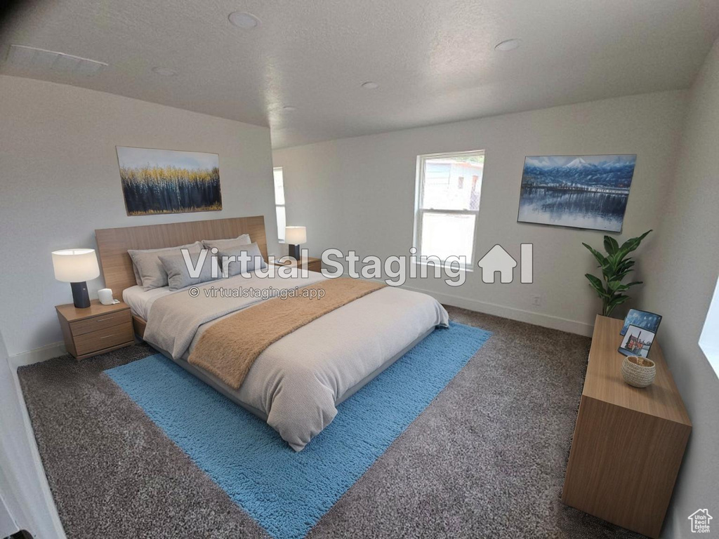 Bedroom featuring carpet floors and baseboards