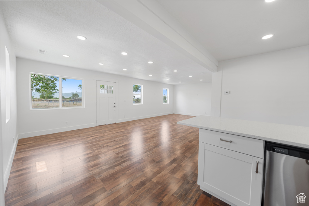 Unfurnished living room featuring recessed lighting and dark wood-style flooring