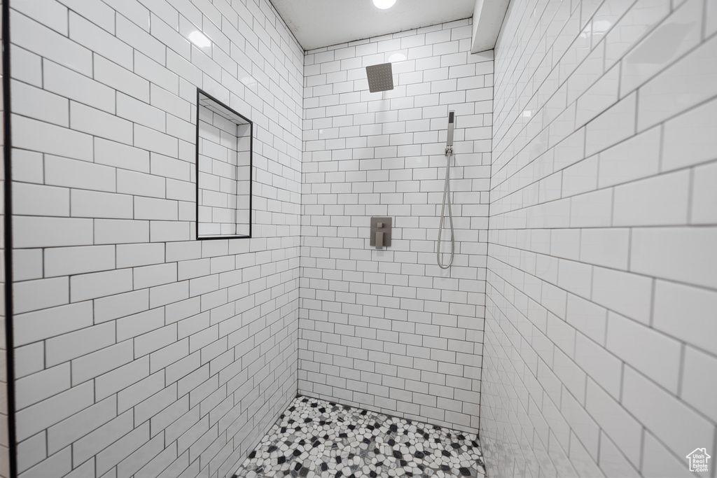 Full bath featuring tiled shower