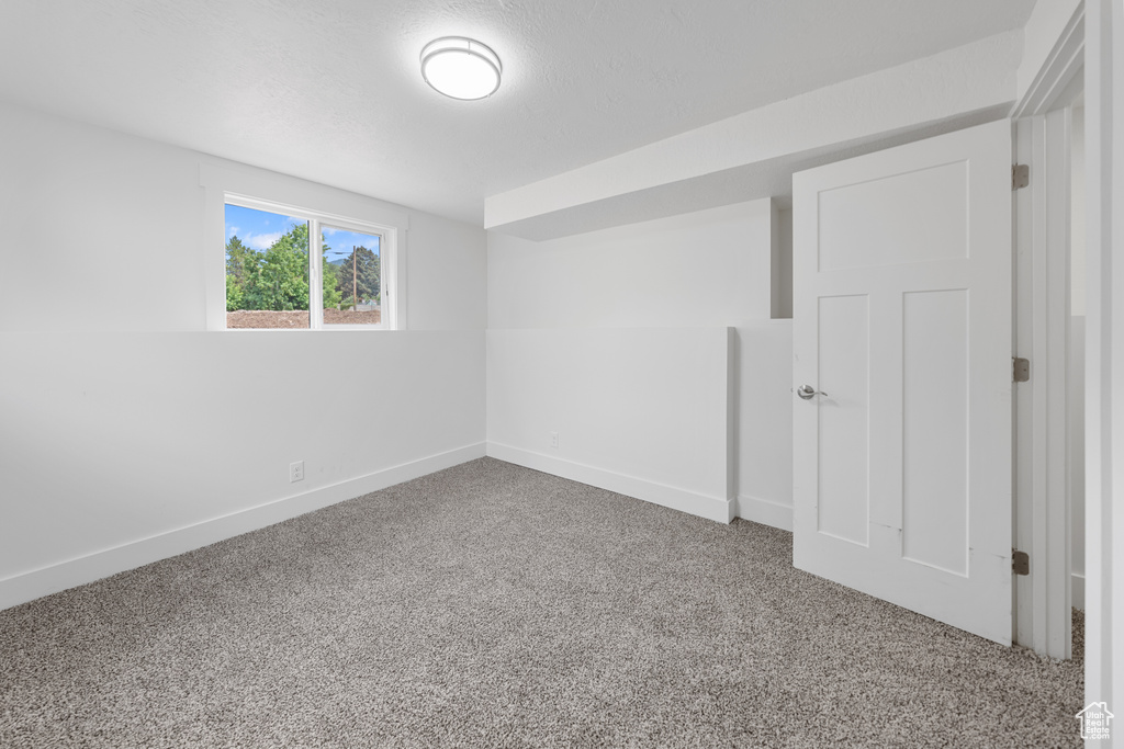 Unfurnished bedroom with carpet flooring and baseboards