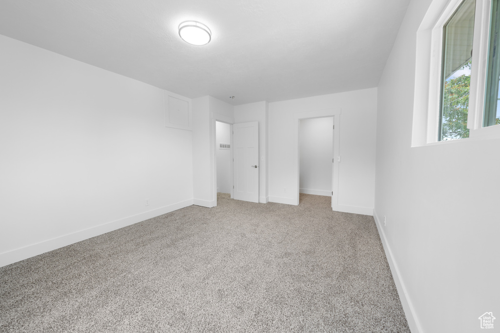 Unfurnished bedroom featuring carpet floors and baseboards