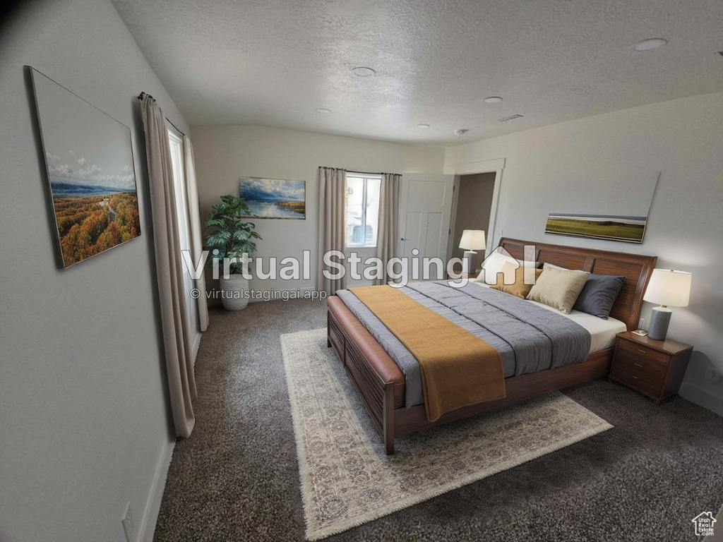 Carpeted bedroom with a textured ceiling and baseboards