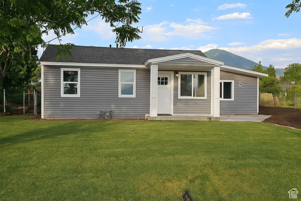View of front of property with a mountain view and roof with shingles