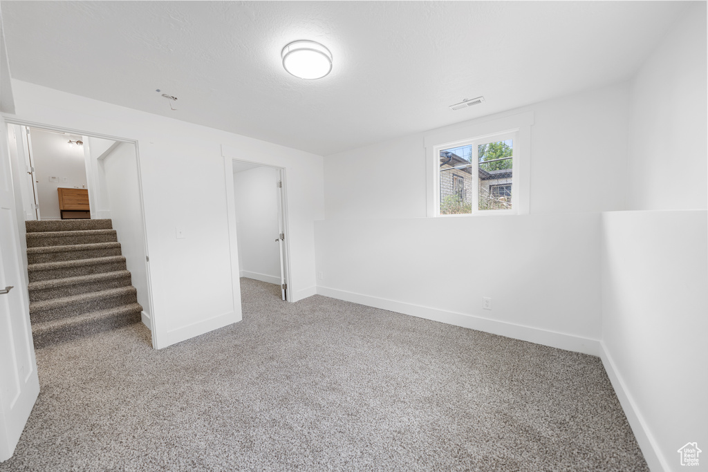 Basement featuring carpet floors and stairway